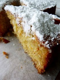 a piece of cake with powdered sugar on top is sitting on a paper towel