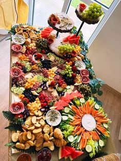 a long table covered in lots of different types of food and desserts on top of it