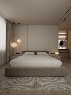 a large bed sitting in the middle of a bedroom next to a wall mounted light