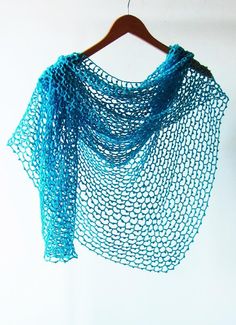 a blue shawl hanging on a wooden hanger