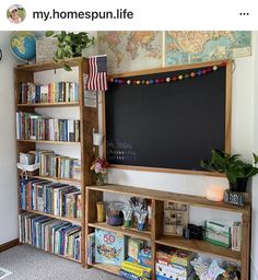 a bookshelf filled with lots of books next to a chalkboard on the wall