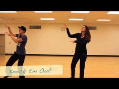 two people are dancing in an empty room