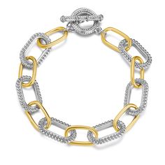 two tone gold and silver link bracelet with diamonds on the clasp, set against a white background