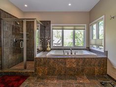 a bathroom with a large tub and walk in shower