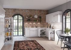 a kitchen with white cabinets and an area rug