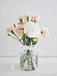 a vase filled with pink and white flowers