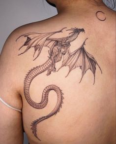 a woman with a dragon tattoo on her back