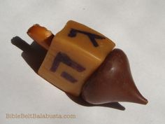 a close up of a toy snail with letters on it's shell and an arrow in the middle