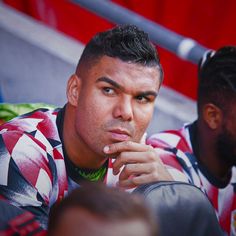 a man sitting next to another man in a stadium