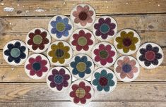 a group of flower shaped rugs sitting on top of a wooden floor