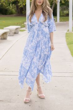 Embrace the season in style with the Avery Midi Dress. Detailing a blue and white abstract print with kimono sleeves and flirty deep v neckline. This midi is perfect for any casual day outings with a jean jacket and sandals or dressed up with heels for date night. Details & Fit: 100% Viscose Runs True to Size Hand Wash Cold Hang To Dry Deep V Neckline Kimono Sleeves Elastic Waist Abstract Print Design Blue | White | Printed Model is 5'6" and wearing a size Small Spring Vacation Maxi Dress With Kimono Sleeves, Spring Dresses With Kimono Sleeves For Day Out, Day Out Dresses With Kimono Sleeves For Spring, Spring Blue Maxi Dress With Kimono Sleeves, Spring Maxi Dress With Kimono Sleeves In Rayon, Blue Rayon Maxi Dress For Spring, Casual Blue Maxi Dress With Surplice Neckline, Blue Maxi Dress With Surplice Neckline For Summer, Casual Dresses With Kimono Sleeves For Brunch