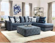 a living room with blue couches and pillows