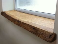 a wooden shelf sitting next to a window