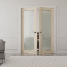 an empty room with two chairs and a large glass door leading to another room that has white walls