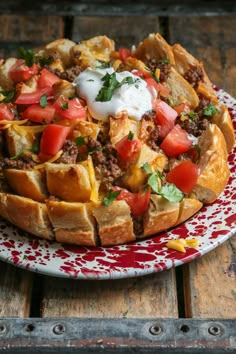 a taco salad on a red and white plate