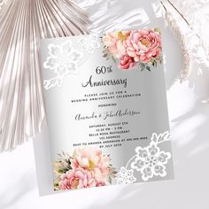 wedding anniversary card with pink flowers and lace on white paper next to palm tree leaves