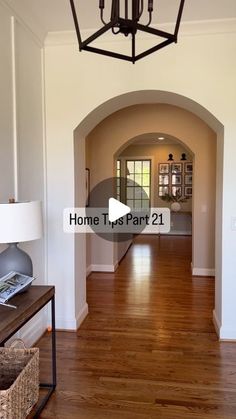 the inside of a house with wood floors and hard wood flooring in front of a chandelier