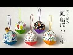 four origami ornaments with chinese characters on them