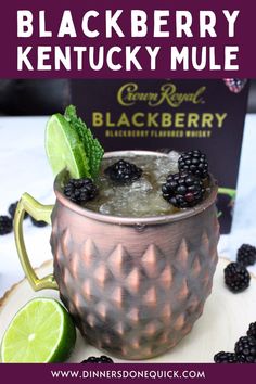 blackberry kentucky mule in a copper mug garnished with lime and blackberries