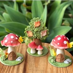 three small mushrooms sitting on top of a wooden table