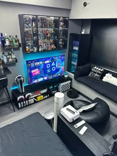 a living room filled with furniture and a flat screen tv mounted to the side of a wall