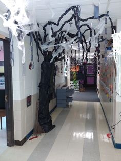 the hallway is decorated for halloween with black and white paper streamers hanging from the ceiling