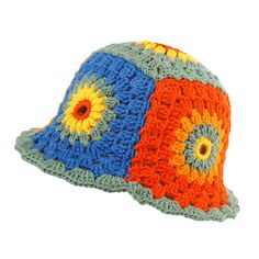 a crocheted hat with an orange, blue and yellow flower on the brim