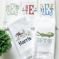 four personalized towels with embroidered animals and letters