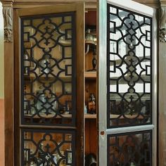 an ornate metal cabinet with glass doors