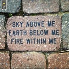 a brick with writing on it that says, sky above me earth below me fire within me