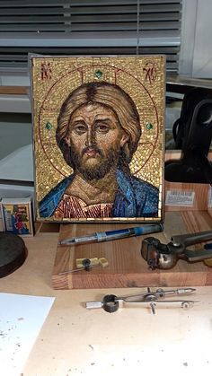 a painting of jesus surrounded by tools on a table