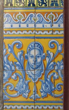 an ornate tile with blue and yellow designs