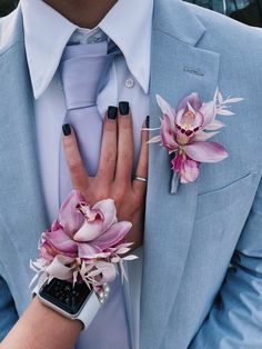 a man in a blue suit and tie with flowers on his lapel flower bouquet