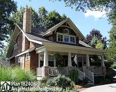 a small house with porches and windows on the front lawn, surrounded by trees