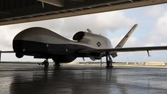 an air force plane sitting on top of an airport tarmac under a cloudy sky