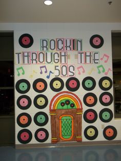 a sign that says rockin through the 50's with record artwork on it