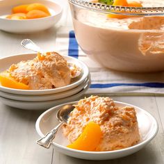 two white bowls filled with food on top of a table