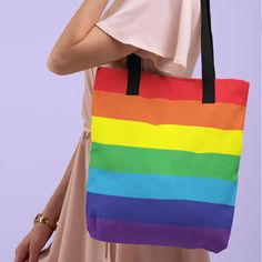 "Fly the rainbow flag with this stunning tote bag. Great for festivals, vacations, gym, shopping and general everyday use. The strong natural cotton denim handles are the perfect size for staying put on your shoulders and it will soon become your go to bag. FEATURES Bag Size 15\" x 15\" (38.1cm x 38.1cm) Handle length 11.8 (30cm) Handle width 1\" (2.5cm) Capacity 2.6 US gal (10 ltr) Weight Limit 44lb (20kg) 100% spun polyester fabric Inside lining color black Our Tote Bags are printed, cut and h Rainbow Shoulder Bag For Everyday Use, Multicolor Canvas Shoulder Bag For School, Rainbow Rectangular Shoulder Bag For Everyday, Casual Rainbow School Bag, Rainbow Rectangular Bag For Everyday Use, Eco-friendly Large Capacity Multicolor Canvas Bag, Eco-friendly Multicolor Canvas Shoulder Bag, Eco-friendly Multicolor Canvas Gift Bag, Eco-friendly Multicolor Canvas School Bag