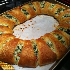 a round bread with spinach and cheese on it