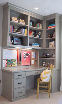 a room with a desk, chair and bookshelves