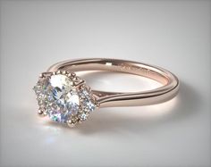 an engagement ring with three stones on the side and a diamond center stone in the middle