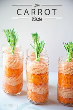 three small jars filled with carrots on top of a table