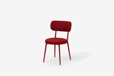 a red chair against a white background with the seat upholstered to it's back