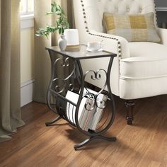 a white chair sitting next to a table on top of a hard wood floor