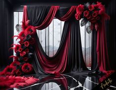 red flowers and black drapes in front of a window