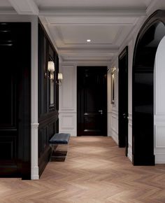 an empty hallway with wooden floors and black walls