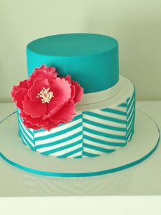 a blue and white cake with a flower on top