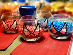 some glass bowls with candy in them on a table