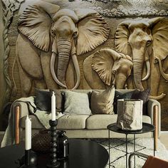 three elephants are depicted on the wall in this living room with couches and chairs