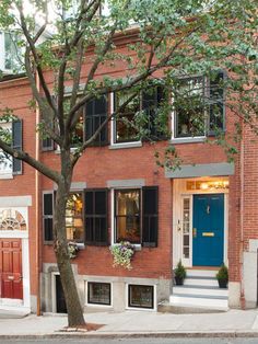 a red brick building with blue door and windows